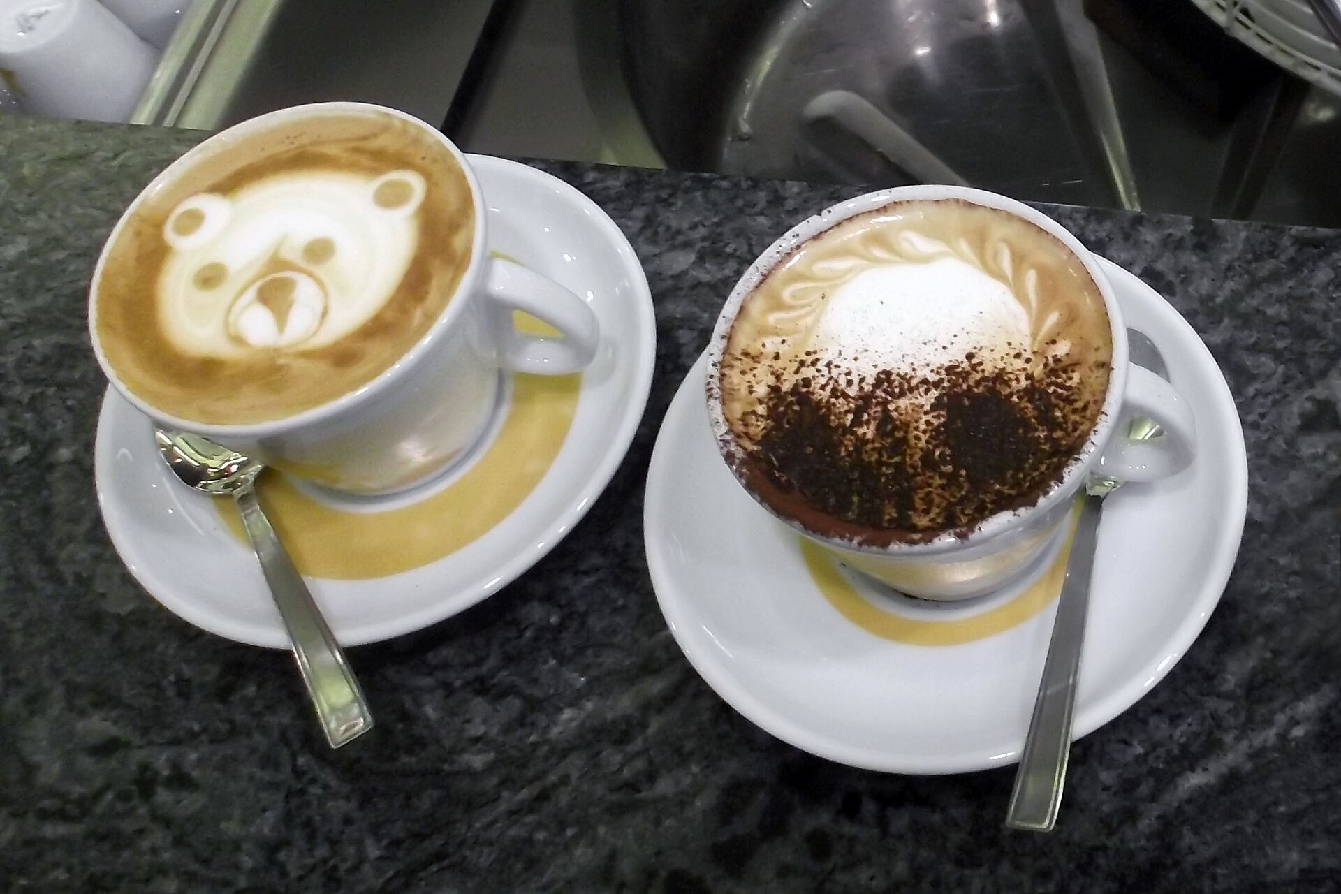 Two cappuccinos on a café counter at Tazza d'Oro