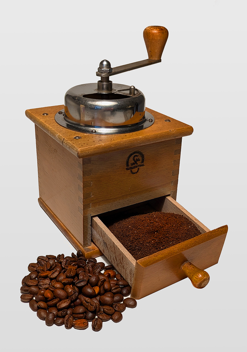 Representative grinder photo for the Grinders category — manual coffee grinder displayed on a wooden shelf.